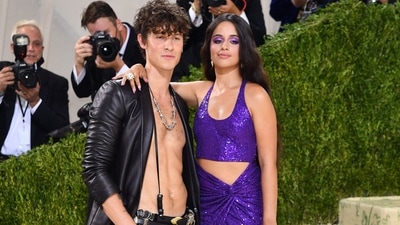 Camila Cabello wore a purple sparkly crop top and skirt, while Shawn Mendes opted for an open leather jacket and black pants. (AFP) 