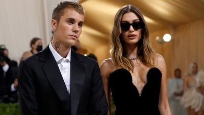 Justin Bieber wore a dark suit with a black suitcase in his hands. His wife Hailey Balwin wore a black gown with a plunging neckline. (Reuters) 