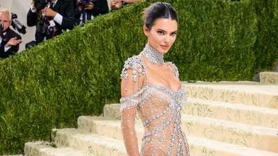 Kendall Jenner arrived at the event in a sheer Givenchy gown adorned with glittering gemstones. The look featured a long train and long sleeves with a bold, diamond-covered choker. She wore strappy heels and had her hair up. (AFP) 
