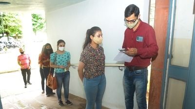 Students wait in queue to get their documents checked before attending their class. (HT Photo) Students wait in queue to get their documents checked before attending their class. (HT Photo)