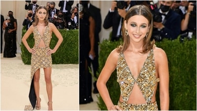 Emma Chamberlain went for a gold mini with cutouts at the waist and chunky mirror and chain detail. (AFP)