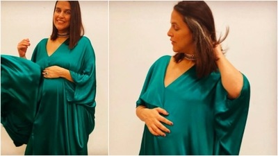 Neha Dhupia opted for this elegant emerald green satin maternity dress for Ganesh Chaturthi. (Instagram/@nehadhupia)