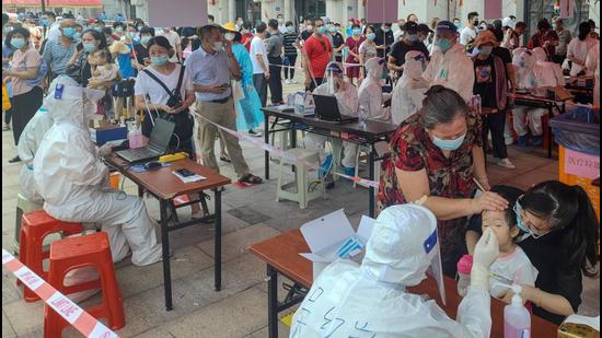 Residents undergo nucleic acid tests for Covid-19 in Xiamen, in China’s eastern Fujian province on Tuesday. China has shut down schools, put in place travel restrictions, and ordered nucleic acid tests for millions in Fujian. (AFP) Residents undergo nucleic acid tests for Covid-19 in Xiamen, in China’s eastern Fujian province on Tuesday. China has shut down schools, put in place travel restrictions, and ordered nucleic acid tests for millions in Fujian. (AFP)