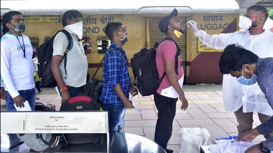 A BMC health worker collects swab samples for Covid test of passengers arriving on outstation trains at Dadar station. (Anshuman Poyrekar/HT Photo)