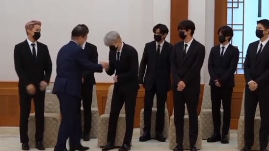 BTS members fist bump South Korean President Moon Jae-in.