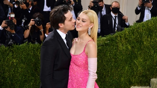 English model Brooklyn Beckham and partner US actress Nicola Peltz shared a kiss as they walked the red carpet at the Met Gala in New York. Brooklyn wore a black tuxedo, and his partner chose a shimmery pink gown with silk opera gloves.(AFP)