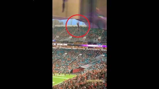 The video posted on Twitter shows cat dangling from a cable at Miami's Hard Rock Stadium during a college football game.&nbsp;(Twitter/@DannyWQAM)