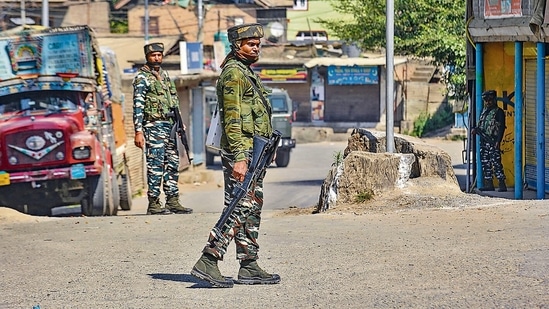 Security personnel stand guard during an encounter, in Pampore, Pulwama. (PTI)