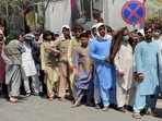 Afghans line up outside a bank to take out their money after Taliban takeover in Kabul.