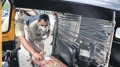 RTO police take action against an auto rickshaw driver in Pune, on September 13. 10,000 autorickshaws operating illegally in Pune, according to the RTO. (RAHUL RAUT/HT)