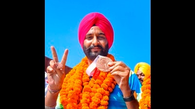 Paralympics bronze medallist Harvinder Singh Dhanju in Patiala on Wednesday. The archer is also a research scholar at Punjabi University. (PTI Photo)