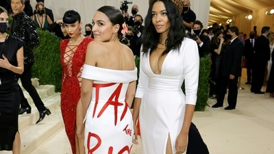 In this file photo taken on September 13, 2021, Alexandria Ocasio-Cortez and Aurora James attend The 2021 Met Gala Celebrating In America: A Lexicon Of Fashion at Metropolitan Museum of Artin New York City. - A proposal making its way through Congress and even adorning the dress of one of its most prominent lawmakers, "tax the rich" has become a rallying cry for Democrats as they seek to remake the United States' social safety net. (AFP) In this file photo taken on September 13, 2021, Alexandria Ocasio-Cortez and Aurora James attend The 2021 Met Gala Celebrating In America: A Lexicon Of Fashion at Metropolitan Museum of Artin New York City. - A proposal making its way through Congress and even adorning the dress of one of its most prominent lawmakers, "tax the rich" has become a rallying cry for Democrats as they seek to remake the United States' social safety net. (AFP)