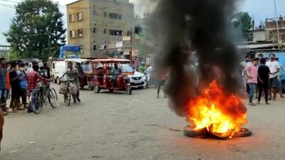 Tyres set ablaze by a protesting mob in Silchar town on Wednesday. (HT photo) Tyres set ablaze by a protesting mob in Silchar town on Wednesday. (HT photo)