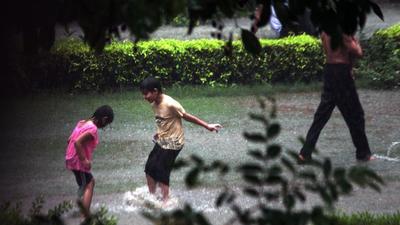 Children playing in the rain in Dwarka, New Delhi. (HT file photo)