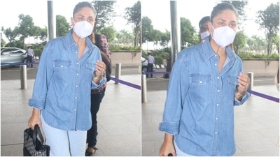 Kareena Kapoor looked as stylish as ever in her chic and comfortable airport ensemble. She chose a loose fitted button-up denim shirt and paired it with a lighter shade of baggy denim pants. (HT Photo/Varinder Chawla)