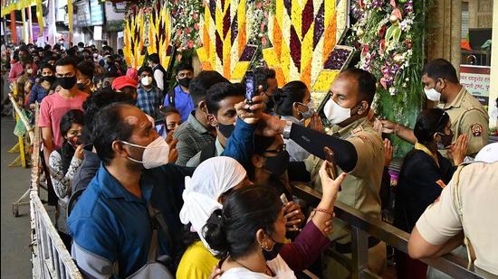 Guard stopping a person from taking a picture at Dagdusheth Ganpati temple in Pune, on September 15. The Pune police have decided not to allow people to take selfies or any photographs at the Ganpati mandaps and in front of Ganpati temples in the city, to avoid crowding. (KALPESH NUKTE/HT)