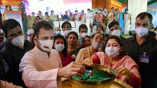 Congress MP Rahul Gandhi lights a lamp during the celebration of the 38th foundation day of Mahila Congress, in New Delhi, on Wednesday. Gandhi said the RSS and BJP are “fake Hindus” who only “use religion for their benefits”. (PTI)