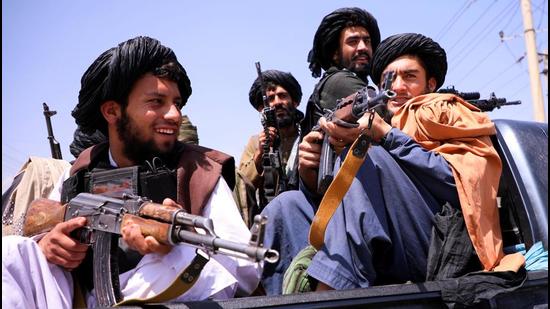 Taliban forces patrol near Hamid Karzai International Airport in Kabul, Afghanistan. China has told Taliban that it will not interfere in Afghanistan’s internal affairs. (REUTERS)