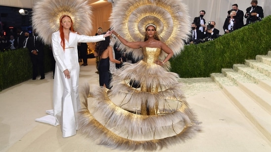 Iman: Fashion designer Harris Reed was responsible for the show-stopping ensemble of Somali-American model Iman. The dress featured a gold baroque-patterned corset and a feathered tiered skirt. The standout feature of the look was its large circular headdress.(AFP)