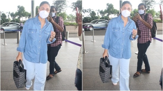 Kareena teamed her ensemble with white chunky lace-up sneakers, a face mask to keep herself safe during the pandemic, and stacked bracelets. She also carried an expensive Christian Dior oblique jacquard saddle tote bag with her jet-set outfit.(HT Photo/Varinder Chawla)