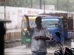 A man covers his head with a cardboard following incessant rainfall in Varanasi on Wednesday.(ANI Photo) A man covers his head with a cardboard following incessant rainfall in Varanasi on Wednesday.(ANI Photo)