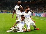 Real Madrid's Rodrygo celebrates scoring their first goal with teammates