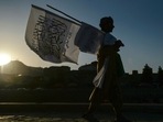 A man selling Taliban flags walks along a street in Kabul on September 15, 2021. (Photo by Hoshang Hashimi / AFP) A man selling Taliban flags walks along a street in Kabul on September 15, 2021. (Photo by Hoshang Hashimi / AFP)