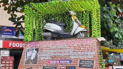 Sachin Dhankude (50), a resident of the Paud road area, has erected a monument of his two-wheeler near Kothrud depot to highlight parking and traffic woes faced by the residents in the city. The photos of the unique decoration have gone viral online. (HT PHOTO)