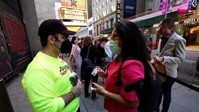 People show their vaccination cards as they wait to attend the Broadway musical ‘Hamilton' at the Richard Rodgers Theatre in New York, as the highest grossing Broadway musical of all time returns after 18 months in the dark due the coronavirus pandemic. (AFP) People show their vaccination cards as they wait to attend the Broadway musical ‘Hamilton' at the Richard Rodgers Theatre in New York, as the highest grossing Broadway musical of all time returns after 18 months in the dark due the coronavirus pandemic. (AFP)