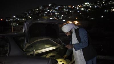 A Taliban fighter checks the trunk of a car at a checkpoint in Kabul, Afghanistan, on Thursday. (AP) A Taliban fighter checks the trunk of a car at a checkpoint in Kabul, Afghanistan, on Thursday. (AP)
