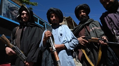 Taliban fighters pose for a picture in front of a bakery at a market area in Khenj district, Panjshir Province. (AFP) Taliban fighters pose for a picture in front of a bakery at a market area in Khenj district, Panjshir Province. (AFP)