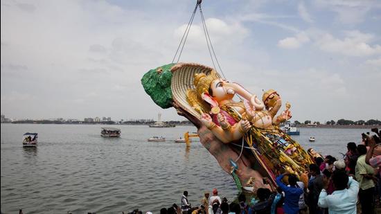An idol of Ganesh is immersed in Hyderabad’s Hussain Sagar Lake (AP)