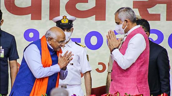 Gujarat chief minister Bhupendra Patel greets Gujarat governor Acharya Devvrat during the state ministerial cabinet swearing-in ceremony in Gandhinagar on Thursday. (PTI)