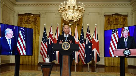 US President Joe Biden participates in a virtual press conference on national security with British Prime Minister Boris Johnson (R) and Australian Prime Minister Scott Morrison in the East Room of the White House in Washington, DC, on Wednesday. The three nations launched the AUKUS partnership. (AFP)