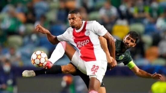 Sporting's Luis Neto, right, vies for the ball with Ajax's Sebastien Haller during a Champions League, Group C soccer match(AP)