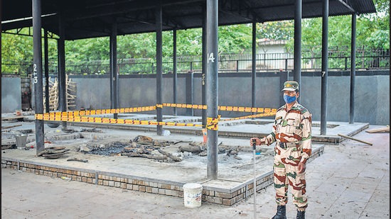 A paramilitary soldier stands guard near a pyre inside a crematorium where a 9-year-old girl from the Dalit community was cremated. Angry villagers held a protest saying the girl was raped and killed.(AP Photo) A paramilitary soldier stands guard near a pyre inside a crematorium where a 9-year-old girl from the Dalit community was cremated. Angry villagers held a protest saying the girl was raped and killed.(AP Photo)