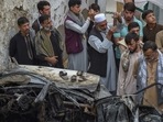 Afghan residents and family members of the victims gather next to a damaged vehicle inside a house, day after a US drone airstrike in Kabul on August 30 Afghan residents and family members of the victims gather next to a damaged vehicle inside a house, day after a US drone airstrike in Kabul on August 30