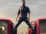 The image shows Ajay Devgn recreating his iconic split.