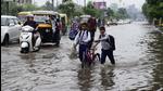 Traffic moving through the waterlogged road near Dholewal Chowk in Ludhiana on Friday. (Harsimar Pal Singh/HT) Traffic moving through the waterlogged road near Dholewal Chowk in Ludhiana on Friday. (Harsimar Pal Singh/HT)