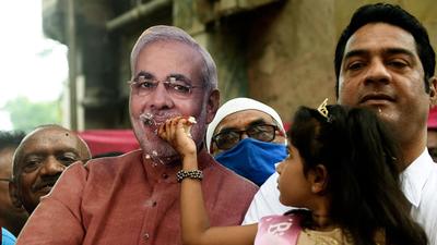 A girl offers cake to a life-size cutout of Prime Minister Narendra Modi on the occasion of his 71st birthday in Ahmedabad on September 17,. (AFP) A girl offers cake to a life-size cutout of Prime Minister Narendra Modi on the occasion of his 71st birthday in Ahmedabad on September 17,. (AFP)