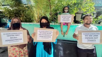 People hold placards during a 12-hour hunger strike against the alleged anti-people policies brought in by the Lakshadweep administration. (ANI) People hold placards during a 12-hour hunger strike against the alleged anti-people policies brought in by the Lakshadweep administration. (ANI)