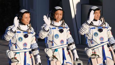 In this file photo, Chinese astronauts Nie Haisheng (C), Liu Boming (R) and Tang Hongbo wave during a departure ceremony before boarding the Shenzhou-12 spacecraft on a Long March-2F carrier rocket at the Jiuquan Satellite Launch Centre in the Gobi desert in northwest China. The three astronauts have completed the country’s longest crewed mission and returned to Earth. (AFP) In this file photo, Chinese astronauts Nie Haisheng (C), Liu Boming (R) and Tang Hongbo wave during a departure ceremony before boarding the Shenzhou-12 spacecraft on a Long March-2F carrier rocket at the Jiuquan Satellite Launch Centre in the Gobi desert in northwest China. The three astronauts have completed the country’s longest crewed mission and returned to Earth. (AFP)
