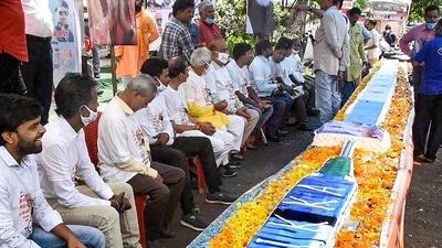 BJP workers sit beside a vaccine shaped cake on the eve of birthday of Prime Minister Narendra Modi, in Bhopal. (PTI) BJP workers sit beside a vaccine shaped cake on the eve of birthday of Prime Minister Narendra Modi, in Bhopal. (PTI)