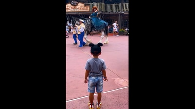 The image shows the boy looking at a person dressed as a Disney Princess. (Instagram/@vanessaguedert)