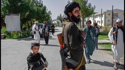 An Afghan boy stands next to a member of the Taliban in front of the Pul-e-Charkhi prison in Kabul. Afghanistan needs the assistance of the international community, especially help from its neighbours, Xi Jinping said. (AFP) An Afghan boy stands next to a member of the Taliban in front of the Pul-e-Charkhi prison in Kabul. Afghanistan needs the assistance of the international community, especially help from its neighbours, Xi Jinping said. (AFP)
