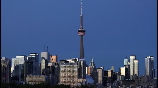 The CN Tower stands at dusk above office buildings and condominiums in the downtown area of Toronto, Ontario, Canada. The Liberal Party has asked one of its candidates from Toronto to halt campaigning over sexual assault allegation. (REUTERS)