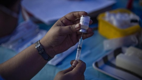 A health worker prepares to administer a dose of Covaxin during a special vaccination drive for homeless and migrant workers against Covid-19 in New Delhi.(AP)