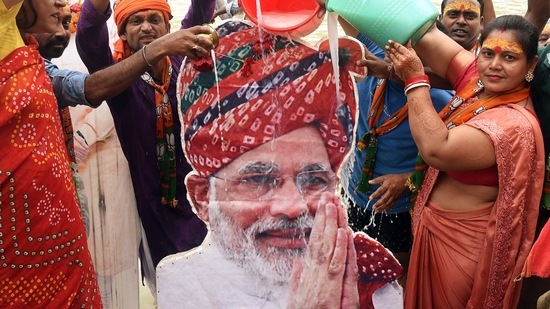 BJP supporters pour milk over the cutout of Prime Minister Narendra Modi on the occasion of his 71st birthday, in Patna.(ANI)