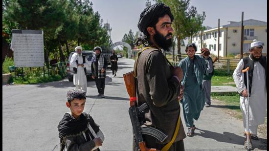 An Afghan boy stands next to a member of the Taliban in front of the Pul-e-Charkhi prison in Kabul. Afghanistan needs the assistance of the international community, especially help from its neighbours, Xi Jinping said. (AFP) An Afghan boy stands next to a member of the Taliban in front of the Pul-e-Charkhi prison in Kabul. Afghanistan needs the assistance of the international community, especially help from its neighbours, Xi Jinping said. (AFP)