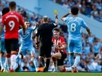 Southampton's Tino Livramento is shown a yellow card by referee Jonathan Moss.